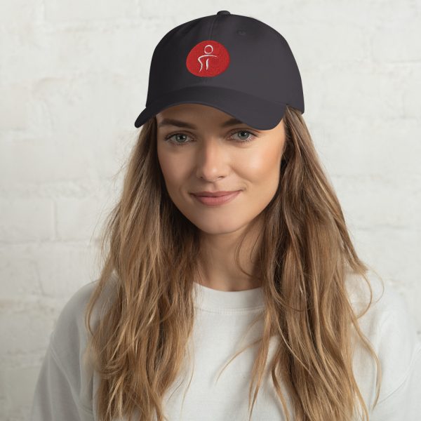 A female wearing a black baseball hat with the Premier Pain Treatment Institute logo on the front