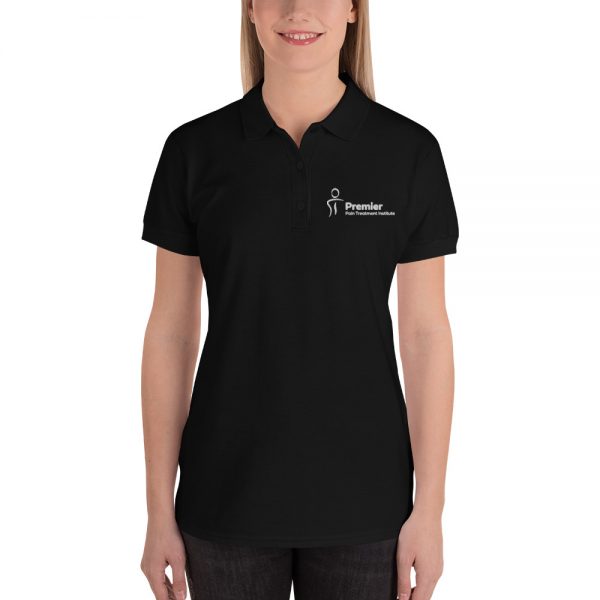 A female wearing a black polo shirt with the Premier Pain Treatment Institute logo on the front