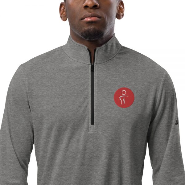 A man wearing a grey Adidas long sleeve shirt with the Premier Pain Treatment Institute logo on the front